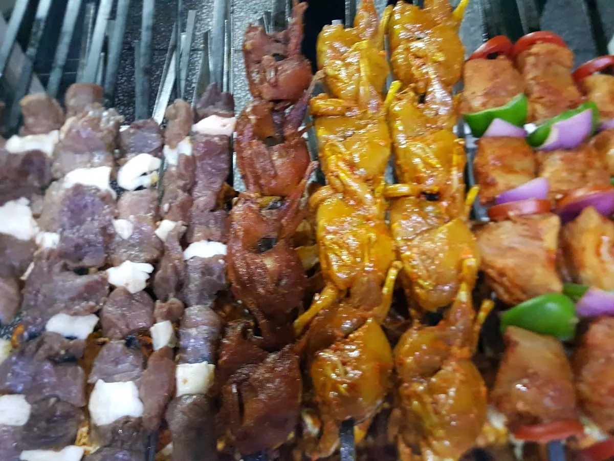 Chicken boti and kebab skewers ready for the grill